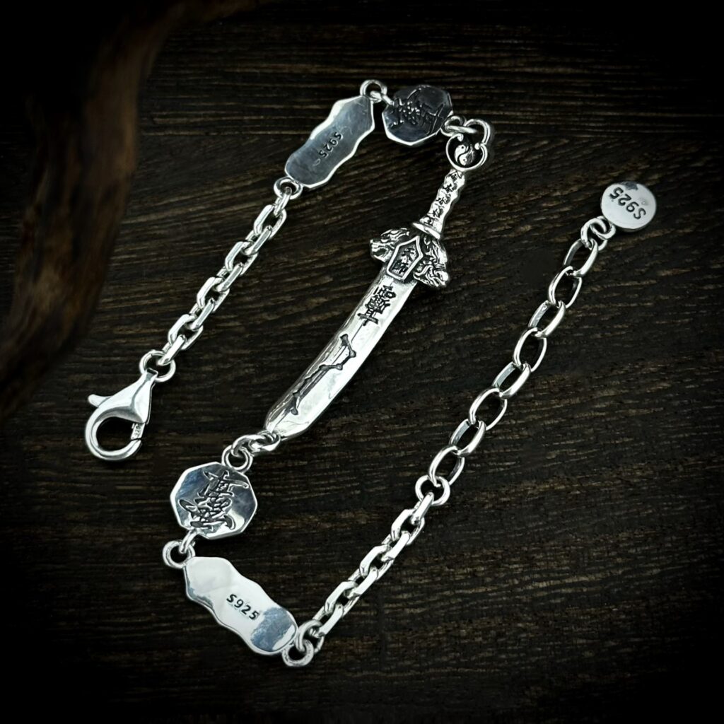 Detailed view of hand carved seven star sword silver bracelet, red cinnabar inlay Taoist symbolic charms vintage oriental craft