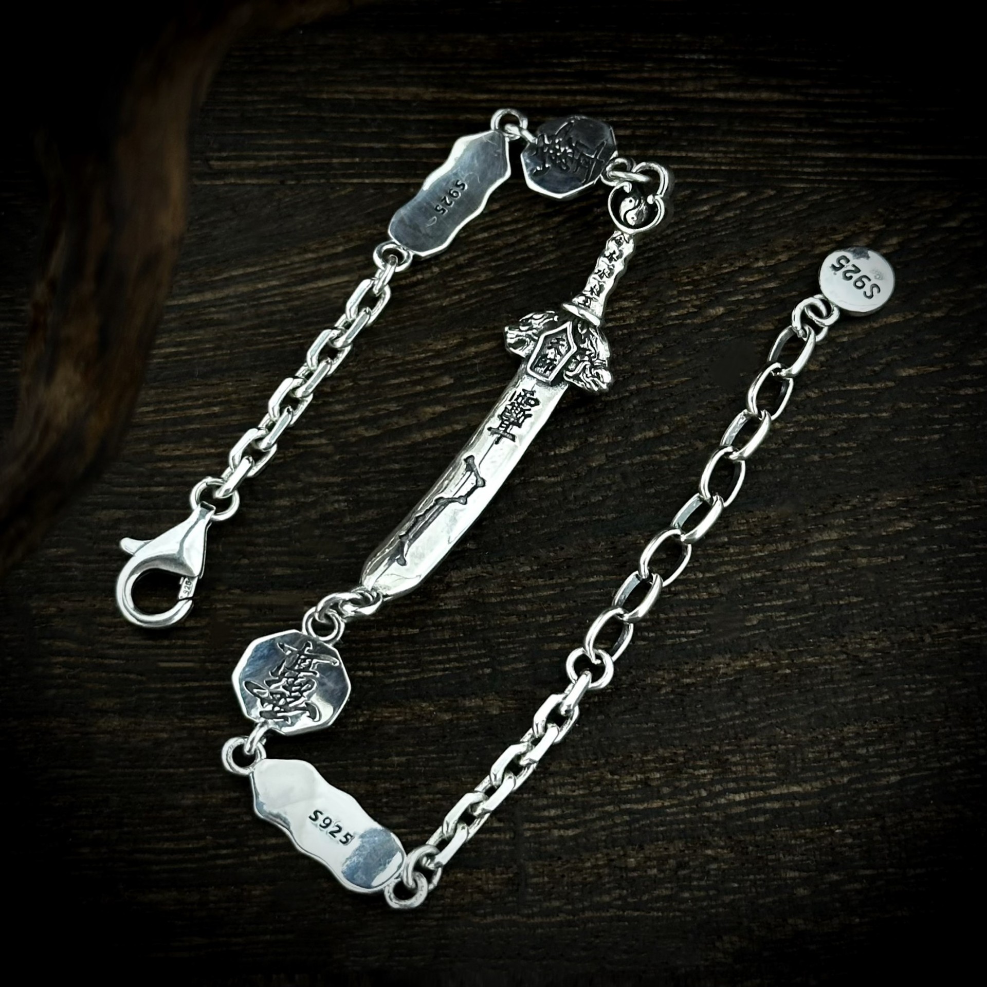 Detailed view of hand carved seven star sword silver bracelet, red cinnabar inlay Taoist symbolic charms vintage oriental craft